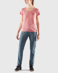 pink round neck t-shirt with Fjällräven logo and blue trousers