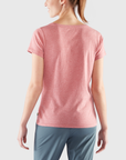 woman wearing pink t-shirt and blue trousers
