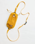 Yellow waist bag with a long strap on a white background