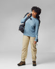 woman wearing light blue long sleeve shirt and beige pants