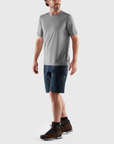 man in shark grey round neck t-shirt and blue shorts
