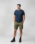Man wearing a navy t-shirt and olive green shorts on a white background