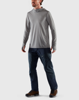 man in shark grey sweater hoodie and navy pants
