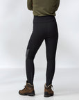 Person wearing black leggings tights and brown hiking boots on a white background