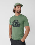 man in green round neck t-shirt with green cap