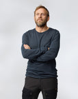 man in navy winter long john and black trousers