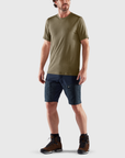 man in green round neck t-shirt and navy shorts