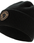 Black knit beanie with a Fjällräven patch on a white background