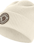 Beige knit beanie with a Fjällräven logo on a white background