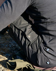 Person wearing a dark jacket with visible G-1000 tag outdoors