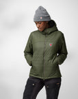 woman wearing deep forest padded puffer jacket with hood and grey beanie