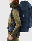 woman carrying navy trekking backpack