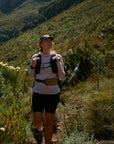Person hiking on a trail in a mountainous area