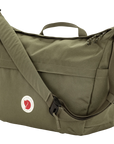 Green shoulder bag with a visible fjallraven logo on a white background