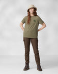 woman wearing green T-shirt with Fjällräven logo and brown trekking trousers and beige bucket hat