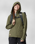 woman in green windbreaker jacket with hood