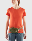 woman in green waist bag with a visible Fjällräven logo