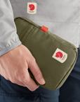 hand holding green small bag with Fjällräven logo