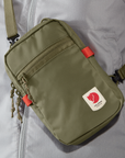 green small sling bag with Fjällräven logo