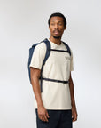 man carrying navy backpack