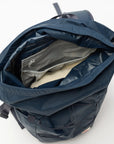 interior opening of navy backpack with rolltop