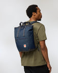 Man wearing a blue backpack on a white background