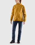 woman wearing yellow windbreaker jacket