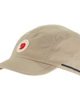 Beige cap with a Fjällräven logo on a white background