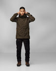 Person wearing a dark brown jacket and black pants on a gray background