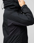 Black jacket worn by a person on a light gray background
