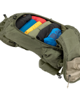 Green backpack with colorful items inside on a white background