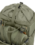 Green backpack with multiple straps and buckles on a white background