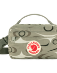 Camouflage-patterned bag with Fjällräven Kånken logo on a white background
