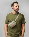 man carrying sling bag across his shoulder