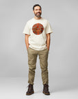 man in chalk white round neck t-shirt and beige trousers