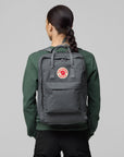 woman carrying grey backpack with Fjällräven logo