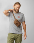 man carrying brown sling bag pouch