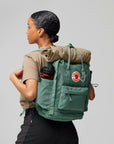 woman carrying kanken backpack with water bottle holder