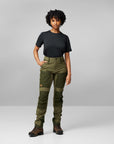 woman in black top and green trekking trousers