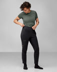 woman in green top and black trekking trousers