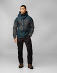 man in iron grey-grey windbreaker jacket with hood and black trousers