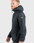 man wearing basalt padded winter jacket with hood and arctic fox logo