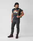 man wearing navy round neck t-shirt and black trousers