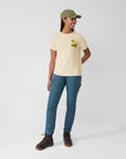 woman wearing chalk white round neck t-shirt and blue trousers