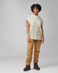 woman wearing chalk white button shirt and brown trousers