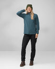 woman in blue fleece jacket and black pants