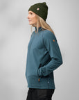 woman in blue fleece jacket and green beanie