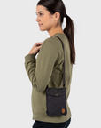 woman carrying black sling bag with arctic fox logo