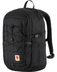 A brown Fjallraven Skule 20 backpack with a front pocket, side mesh pocket, and adjustable shoulder straps.