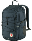 A brown Fjallraven Skule 20 backpack with a front pocket, side mesh pocket, and adjustable shoulder straps.